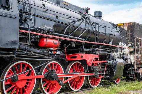 Rusty old steam train showcasing intricate details at a historic railway site on Stock Photos