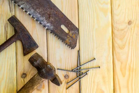 Rusty old tools are laid out on a wooden background Stock Photos