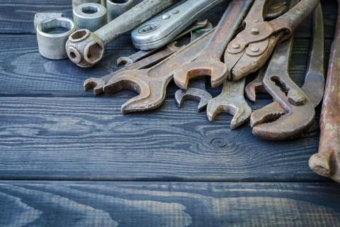 Rusty Old Tools on black vintage wood background. Stock Photos