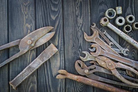 Rusty Old Tools on black vintage wood background. Stock Photos