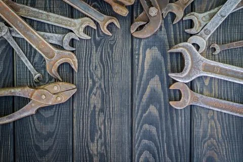 Rusty Old Tools on black vintage wood background. Stock Photos