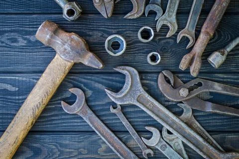 Rusty Old Tools on black vintage wood background. Stock Photos
