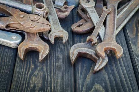 Rusty Old Tools on black vintage wood background. Stock Photos
