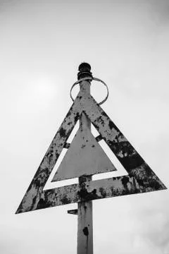 Rusty old triangular navigation mark 스톡 사진