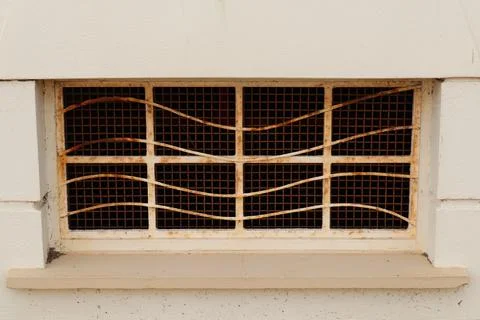 Rusty old window on the side of a building Stock-Fotos