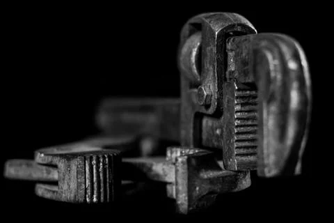 Rusty, old workshop keys. Hydraulic keys on a black table in a workshop. Blac Stock Photos