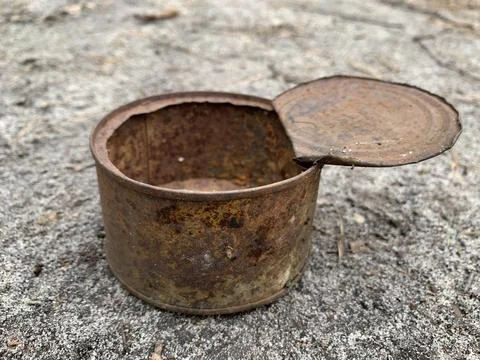 Rusty open tin can. An old iron can of canned food. Stock Photos