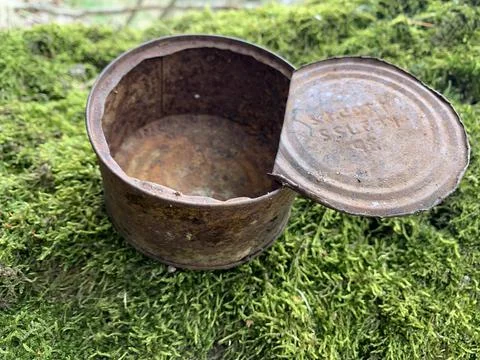 Rusty open tin can. An old iron can of canned food. Stock Photos