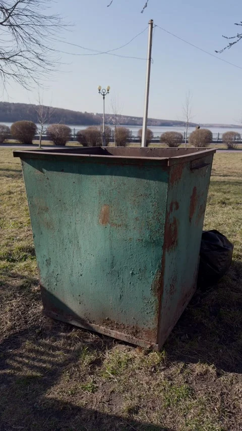A Rusty Outdoor Bin Positioned by the Waters Edge in a Peaceful Natural Stock Footage 305268055