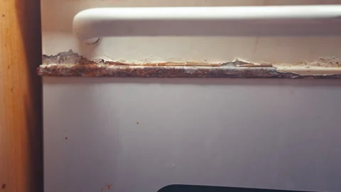 Rusty Oven Door Close-Up Slow Motion Pan | Peeling Paint and Corrosion on Old Stock Footage 344085985