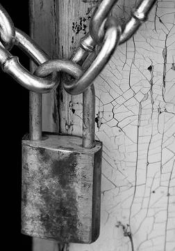 Rusty Padlock and Chain on Weathered Door Stock Photos