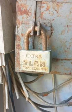 Rusty padlock hanging on electrical panel Stock Photos