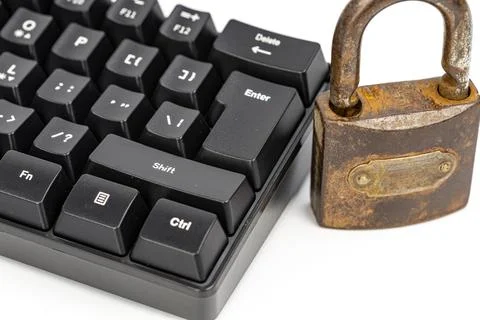 Rusty padlock next to black computer keyboard symbolizing online security Stock Photos