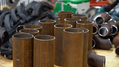 Rusty pieces of pipes on floor on background of grinders, metal wire close up Stock Footage 126355821