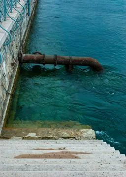 Rusty pipe in the river Stock Photos