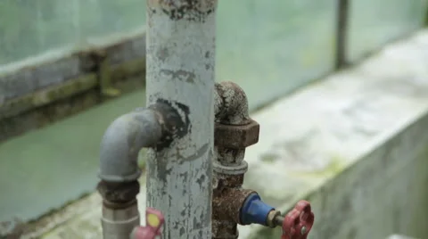 Rusty pipe tap in a greenhouse Video stock 62777445