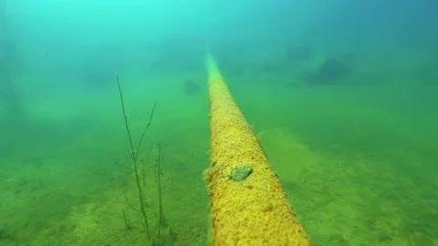 Rusty pipe underwater at old quarry filled by water Stock Footage 156792968