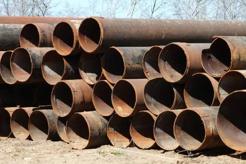 The rusty Pipes of large diameter stored on the ground. Stock Photos