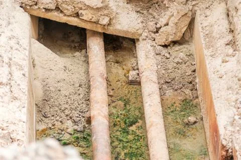 Rusty pipes in the pit Stock Photos