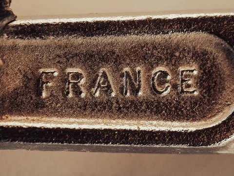 Rusty plaque bears embossed word "FRANCE" in bold letters Stock-Fotos