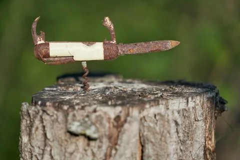 Rusty pocketknife on top of a stump Stock Photos