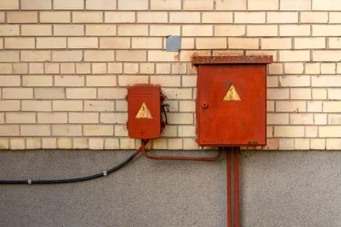 Rusty power supply box on the brick wall Stock Photos