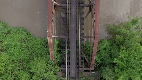 Rusty railway bridge over the river from above 4K aerial video Stock Footage 113887312