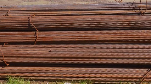 Rusty rebar bundles lying at construction site Stockbeeldmateriaal 335142925