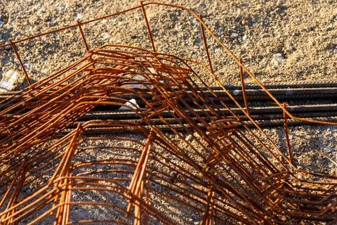 Rusty rebar mesh lying on sand at construction site Stock Photos