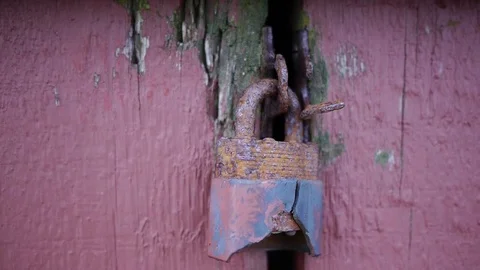 Rusty red and blue old door lock Stock Footage 78033161