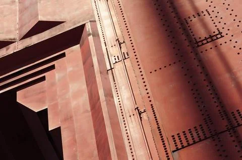 Rusty red industrial structure with geometric patterns and shadows Stock Photos