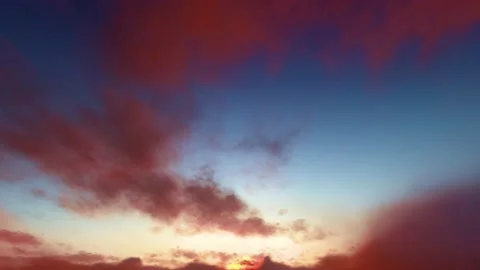 Rusty red magenta storm clouds blue sky dusk sunset time lapse seamless loop Video stock 159707030