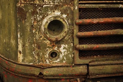 Rusty retro bus with broken headlight close up Stock Photos