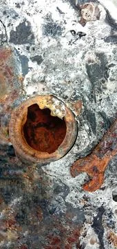 Rusty ring spanner above the motorcycle tank hole Photos