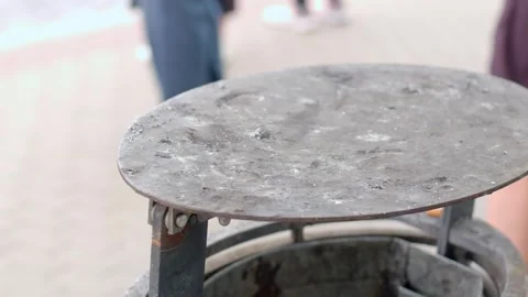Rusty round trash bin lid lifted on hinge at outdoor graduation Видео 347205413