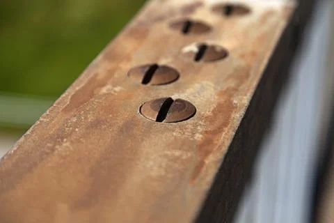 Rusty screws on a bridge railing Stock Photos