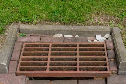 Rusty sewer grate. Stock Photos