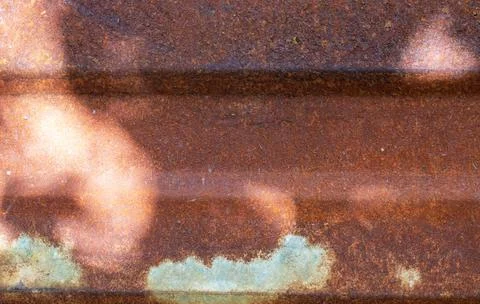 A rusty sheet of iron, illuminated by the sun, with patches of shadow Stock Photos