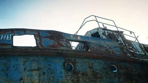 The rusty side of an old tanker with peeling paint. Desolation, death, end of Stock Footage 257766619