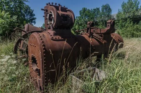 Rusty steam engine on a deserted terrain Stock Photos