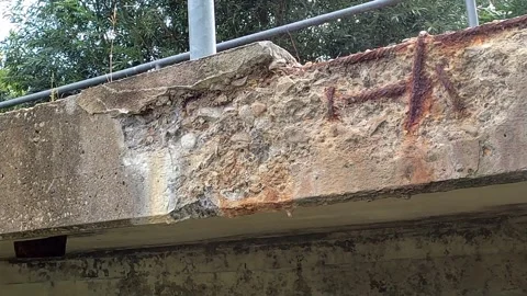 Rusty structural steel and flaking concrete parts on a bridge Stock Footage 246801521