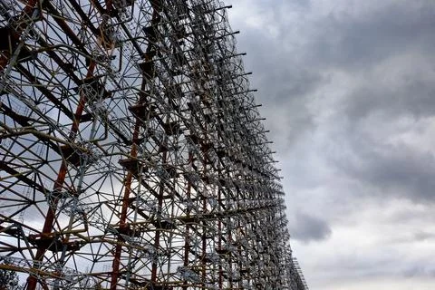 Rusty structures filled with a web of cables and wires. Duga Foto stock