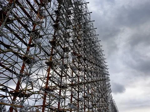 Rusty structures filled with a web of cables and wires. Duga Stock Photos