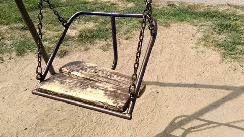 Rusty swing sways in the wind Video stock 129778978