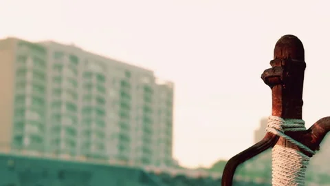 Rusty sword displayed outdoors against city skyline during sunset Stock Footage 340024195