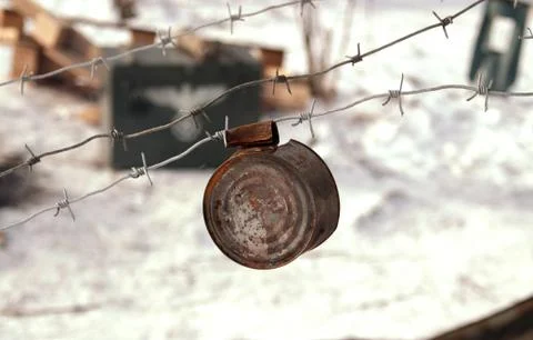 Rusty tin can on the barbed wire Фото