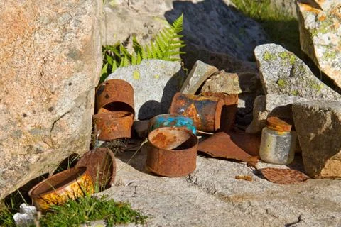 Rusty tin cans left behind in mountain camp Stock Photos