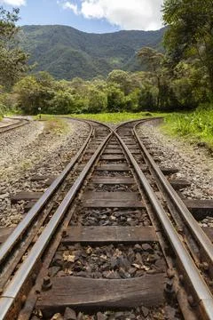Rusty train tracks, surrounded by the Amazon cloud forest, Peru. Stock Photos