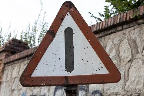 Rusty triangular warning sign showing exclamation mark Stock Photos