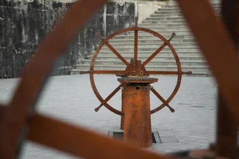 Rusty Valve in shape of wheel for opening a river dam Stock Photos
